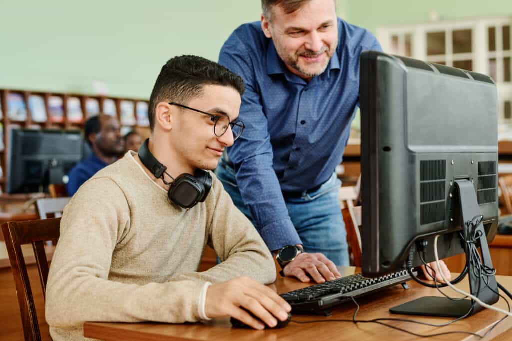 Two person looking at computer