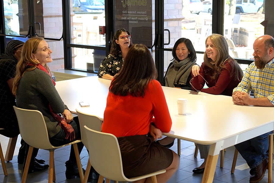 Bentley colleagues talking at a table