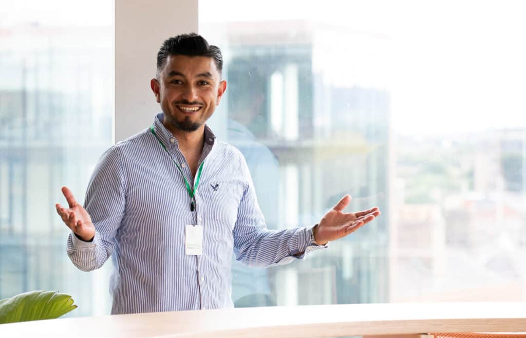 Coworker smiling by a window in the Ireland office | Bentley Systems | Infrastructure Engineering Software Company Coworker smiling by a window in the Ireland office