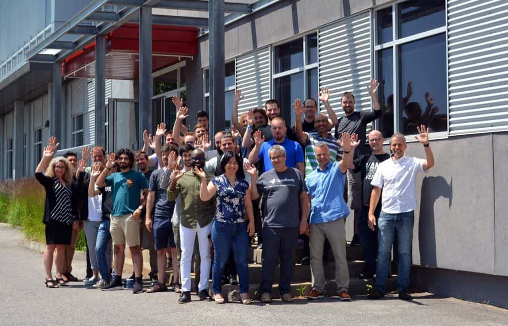 Group photo standing outside of front entrance from Quebec Bentley office | Bentley Systems | Infrastructure Engineering Software Company Group photo standing outside of front entrance from Quebec Bentley office