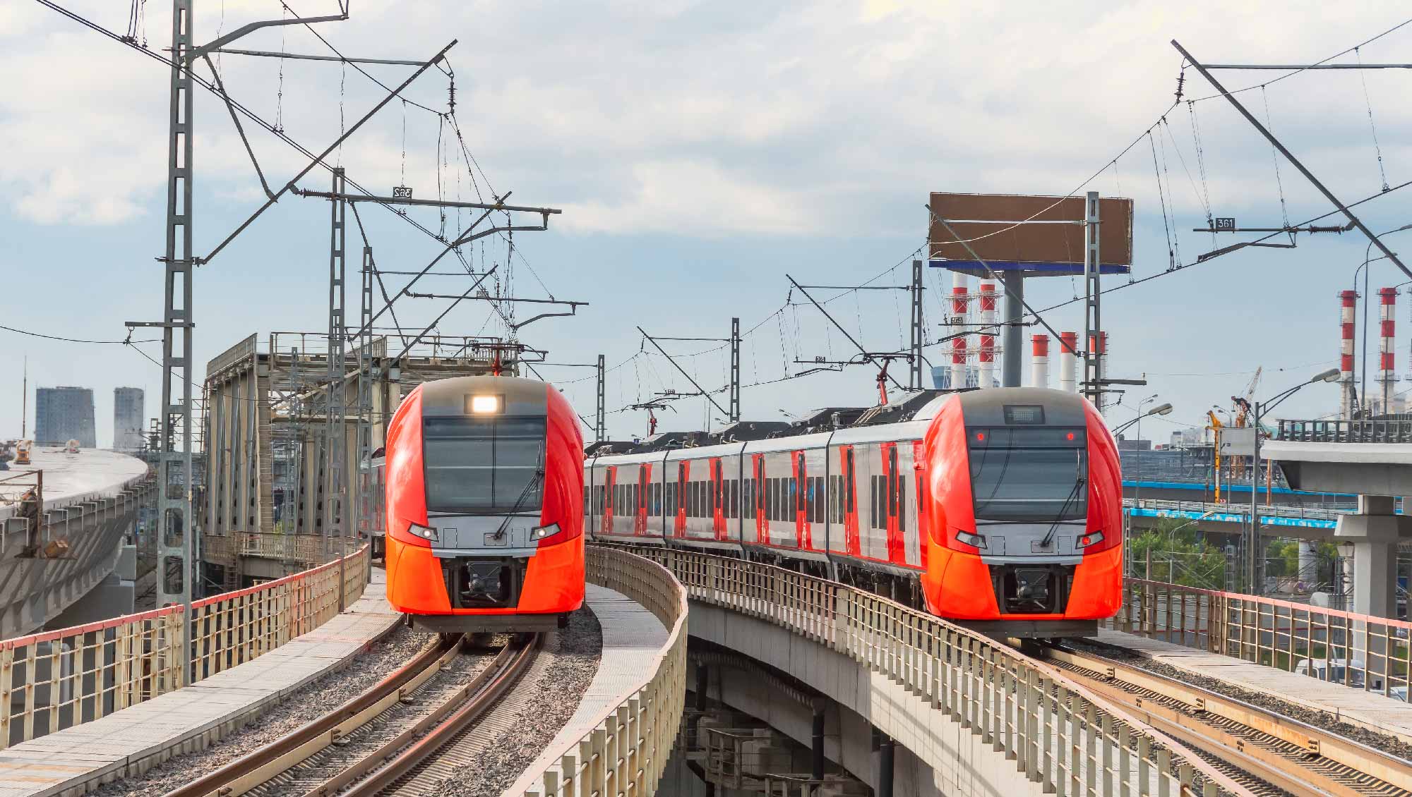 red metro trains coming towards you running on rail tracks