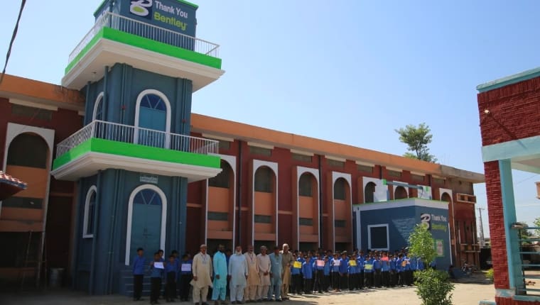 People in Pakistan standing outside of building