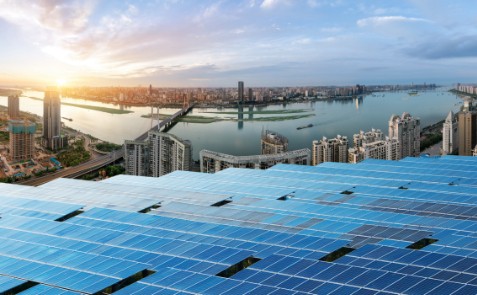 Solar panels overviewing a city and river | Bentley Systems | Infrastructure Engineering Software Company Solar panels overviewing a city and river