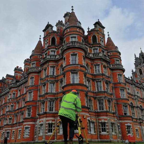 man looking at building at campus of Royal Holloway | Bentley Systems | Infrastructure Engineering Software Company man looking at building at campus of Royal Holloway