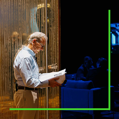 Greg Bentley reading a script on stage during the 2023 Year in Infrastructure and Going Digital Awards