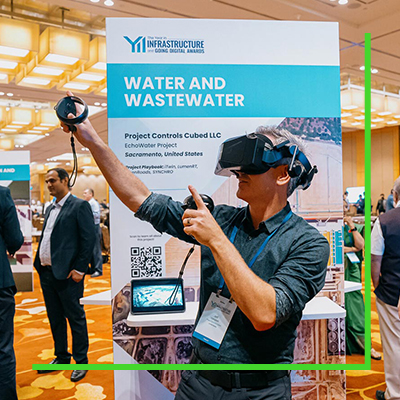A man wearing a virtual reality headset at a water and wastewater infrastructure conference booth.