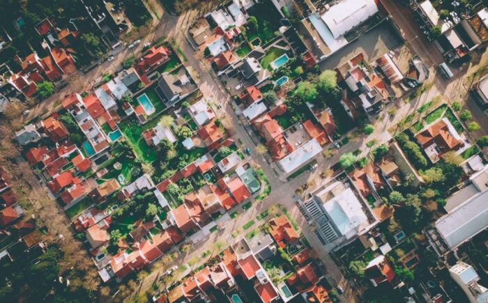 An aerial view of an urban residential neighborhood with trees.