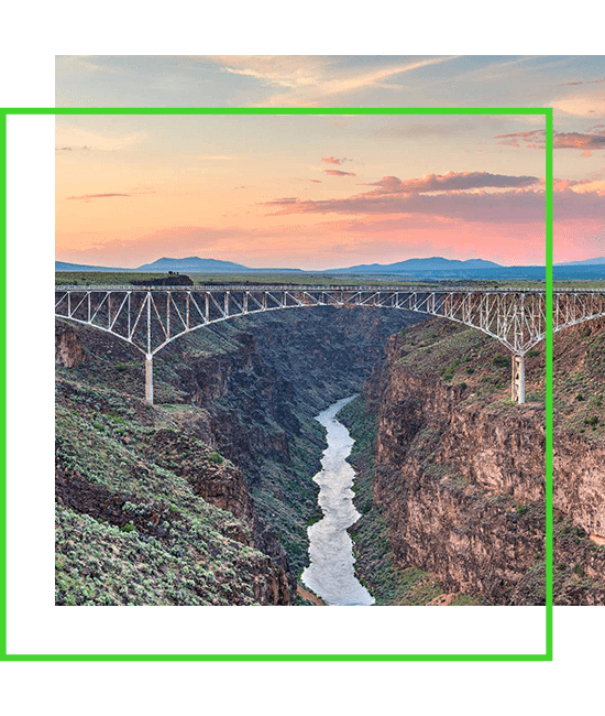 bridge across gorge and river at sunset | Bentley Systems | Infrastructure Engineering Software Company bridge across gorge and river at sunset