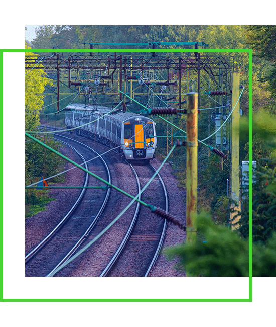A green border with a train on the tracks. | Bentley Systems | Infrastructure Engineering Software Company A green border with a train on the tracks.