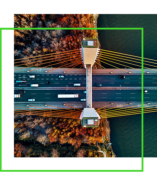 an aerial view of a bridge going a river with an overlapping green border | Bentley Systems | Infrastructure Engineering Software Company an aerial view of a bridge going a river with an overlapping green border