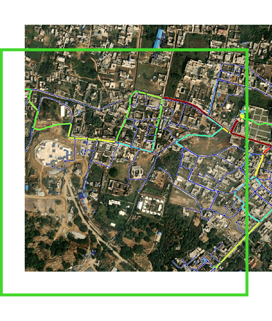 A satellite image shows a map of a city with colored lines indicating water network. | Bentley Systems | Infrastructure Engineering Software Company A satellite image shows a map of a city with colored lines indicating water network.